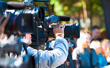 Camera crew filming and broadcasting with portable enterprise internet